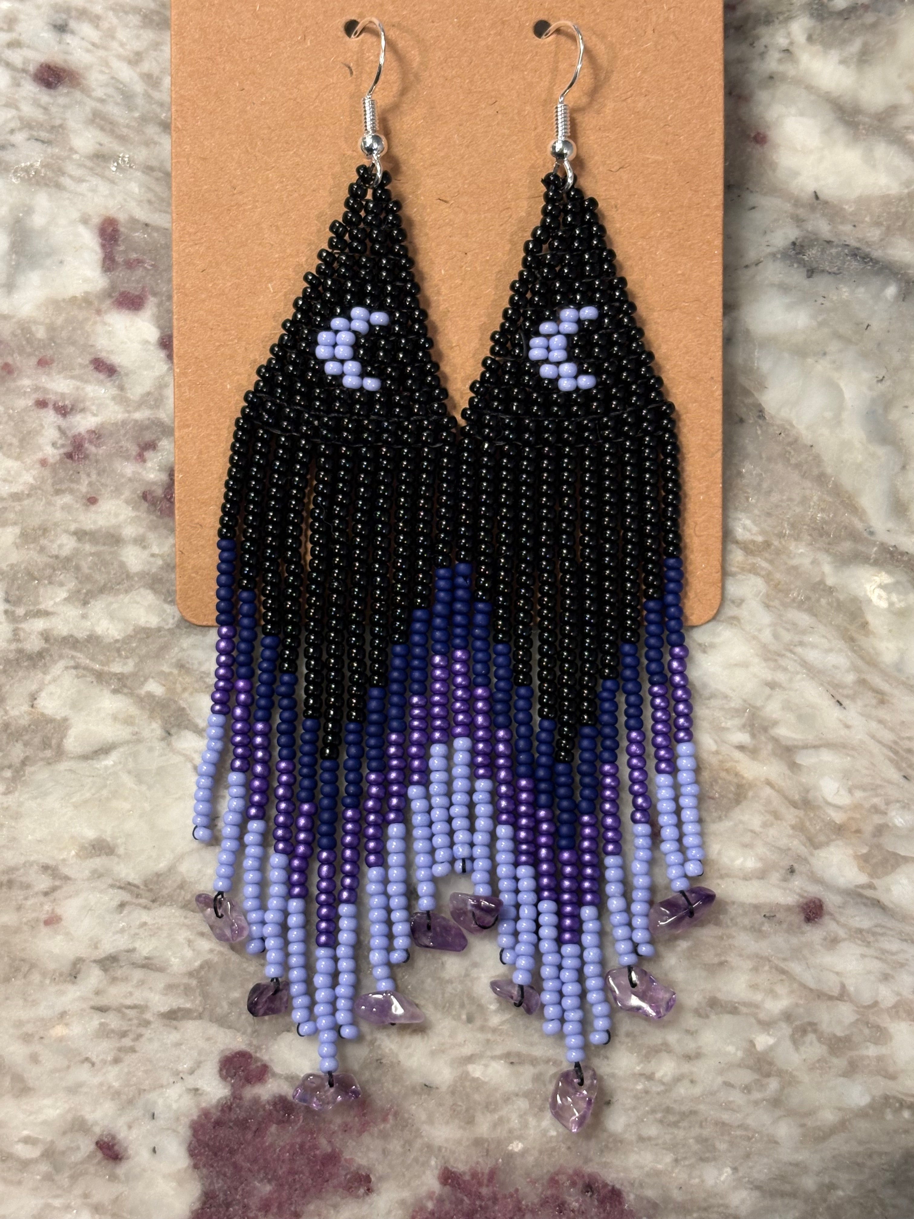 Purple Rain beaded fringe earrings on display card on marble
