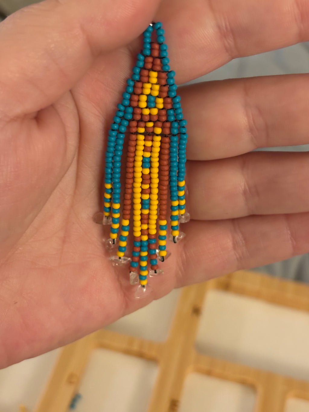 Close up of Quartz Mine earring held in hand showing detail