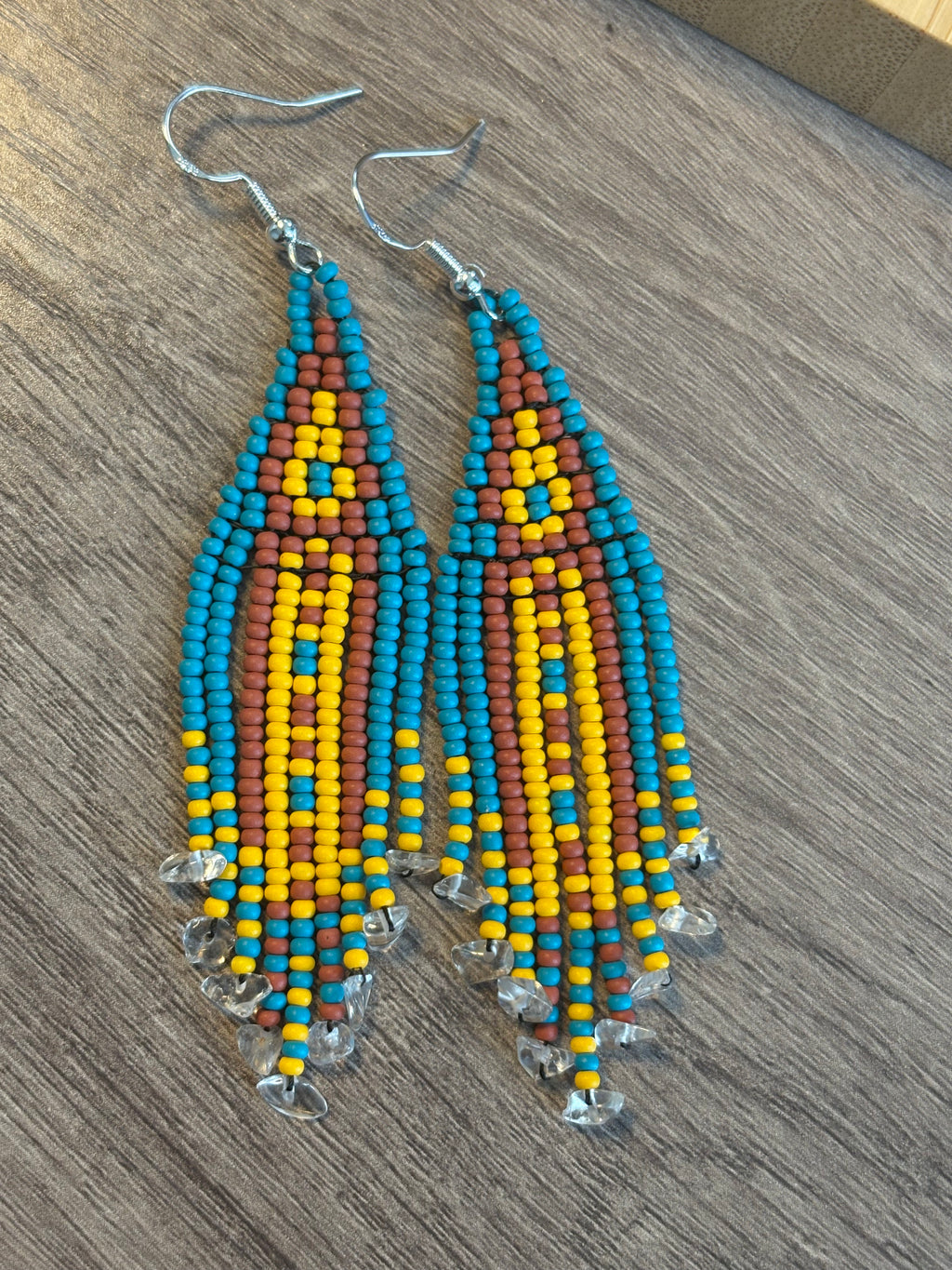 Quartz Mine beaded fringe earrings flat lay on wood surface